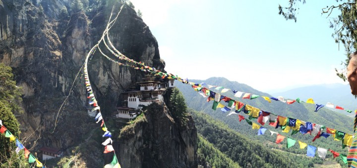 Bhutan tour guide Denzin gazes across the path of prayer flags to the Tiger’s Nest temple and monastery.