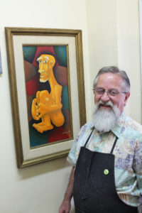 Adams with the painting returned by Dick Hudson. Photo courtesy: Sheet staff.