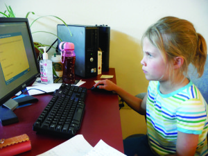 Lila Creasy, who has read the most books in the Mammoth Library summer reading program, focuses intently on a test. Photo courtesy: Bodine.