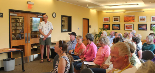 Mammoth Lakes Branch Manager Doug Oldham (standing) addresses the MCOE Board in front of a packed house on Aug. 27. Photo courtesy: Vane.