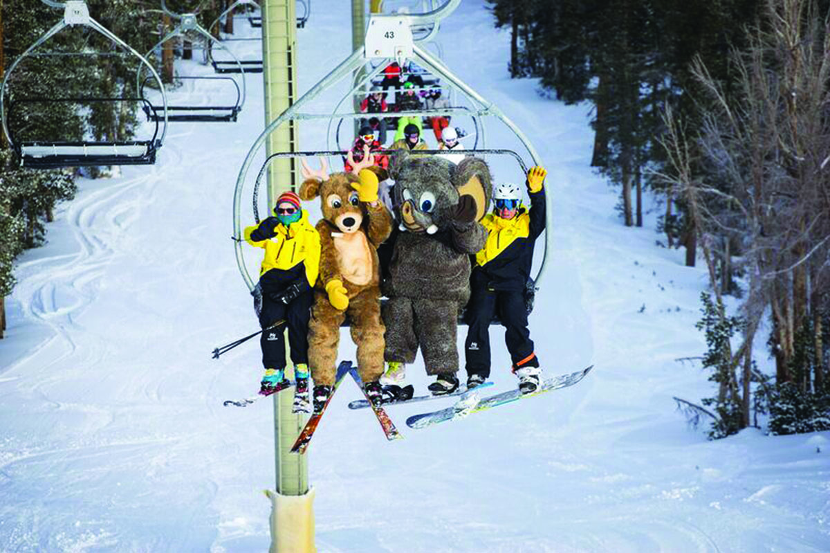 Bucky and Woolly ride the lift with June Mountain employees Jody Aas and Wayne Toussaint. Photo courtesy: Christian Pondella.